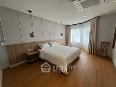 Spacious bedroom with modern design and large windows for natural light