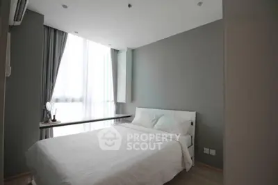 Modern minimalist bedroom with natural light and sleek design