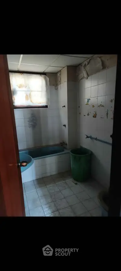 Cozy bathroom with bathtub and tiled walls, ideal for renovation projects.