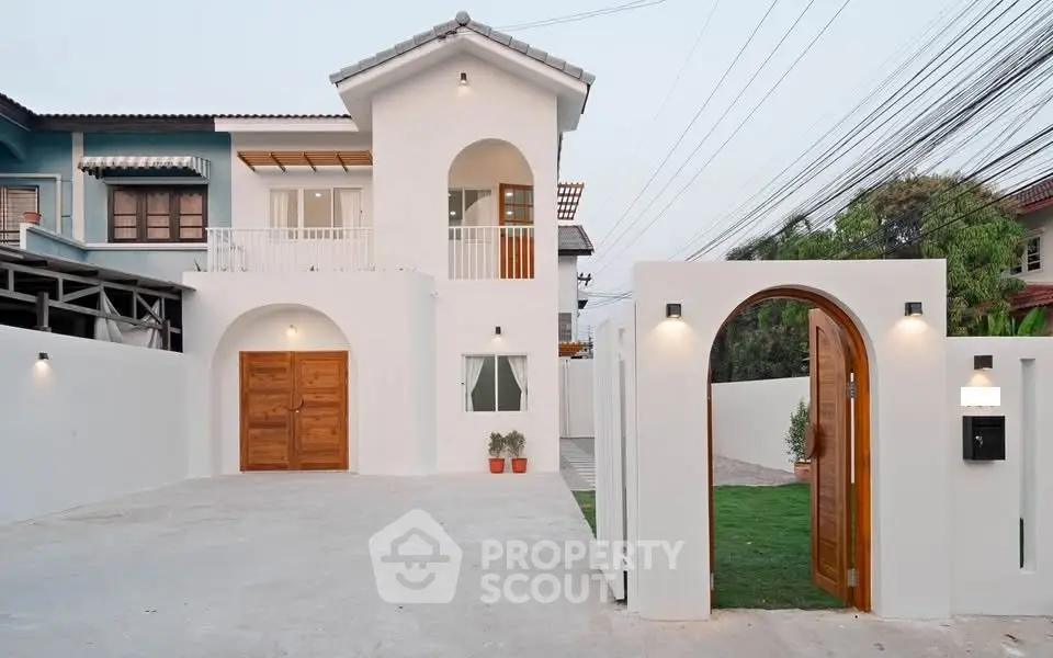 Stunning modern two-story house with elegant white facade and wooden accents, featuring a spacious driveway and lush greenery.
