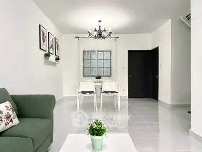 Modern living room with elegant chandelier and cozy dining area