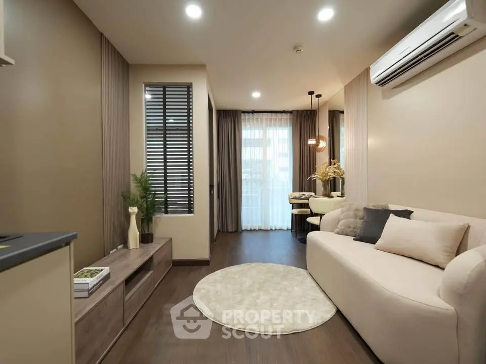 Modern living room with elegant decor and natural light, featuring a cozy sofa and stylish furnishings.