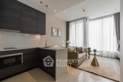 Modern open-layout kitchen and living room with sleek design and natural light.