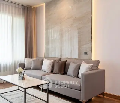 Elegant living room with modern sofa and marble accent wall