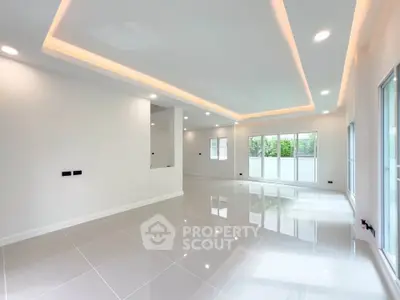 Spacious modern living room with sleek tile flooring and recessed lighting