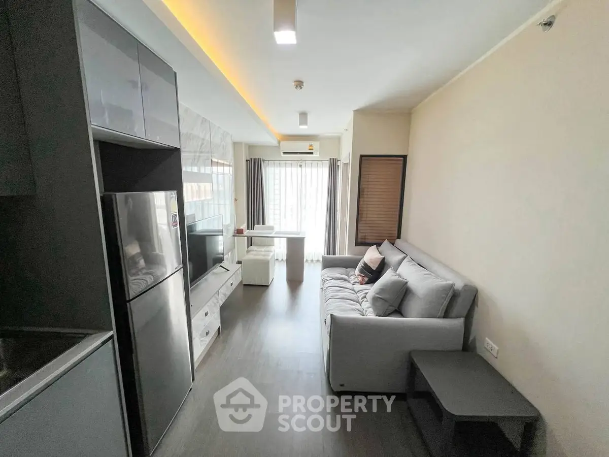 Modern living room with sleek design and natural light, featuring a cozy sofa and stylish decor.