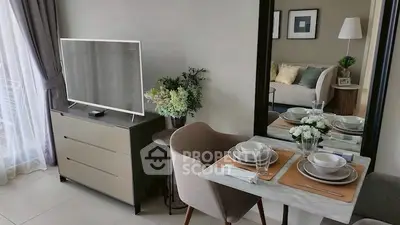 Modern living room with stylish dining setup and large TV, perfect for cozy gatherings.