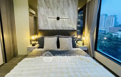 Luxurious bedroom with modern decor and stunning city view from large window.