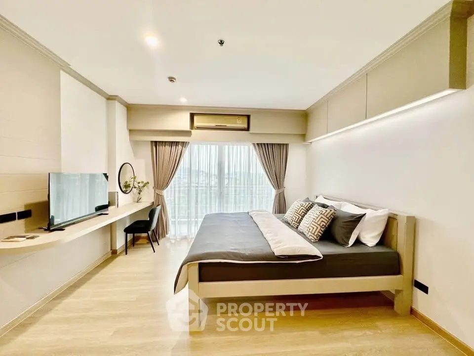 Spacious modern bedroom with natural light and stylish decor