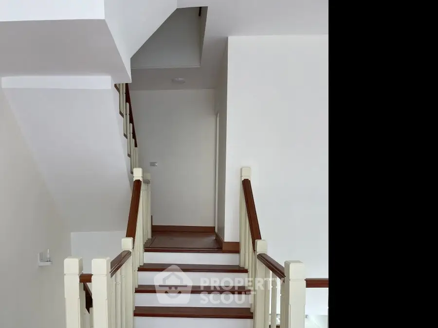 Elegant staircase with wooden railings in a modern home interior