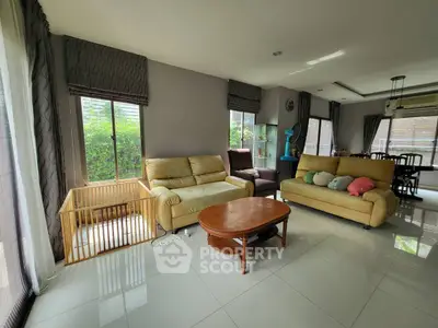 Spacious living room with modern decor and large windows for natural light.