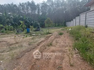 Spacious land plot with lush greenery and potential for development in a serene environment.