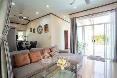 Spacious living room with modern decor and large windows for natural light.