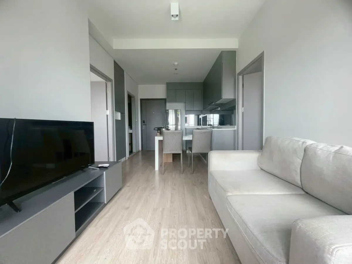 Modern living room with open kitchen layout and sleek furniture design