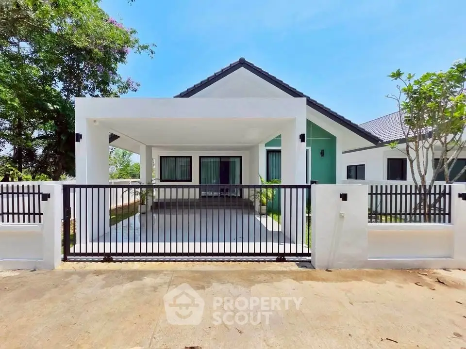 Charming modern house with spacious driveway and lush greenery, perfect for family living.