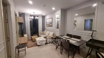 Modern living room with elegant dining area and cozy seating in a stylish apartment.