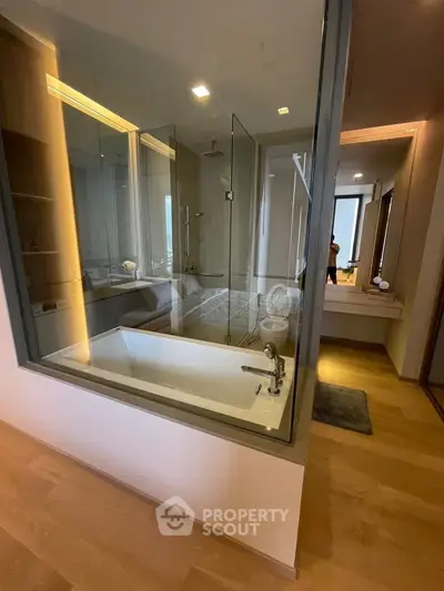 Luxurious bathroom with glass shower and modern bathtub in elegant apartment