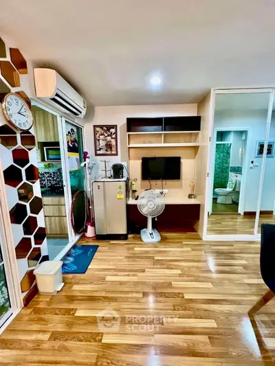 Modern living room with wooden flooring, air conditioning, and stylish decor