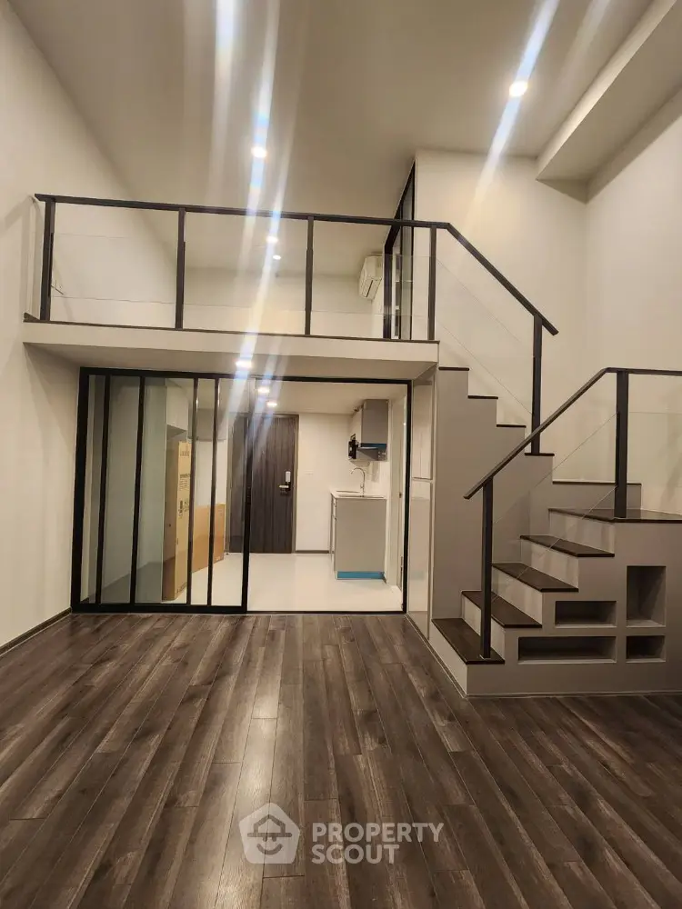 Modern loft apartment with mezzanine and sleek wooden flooring