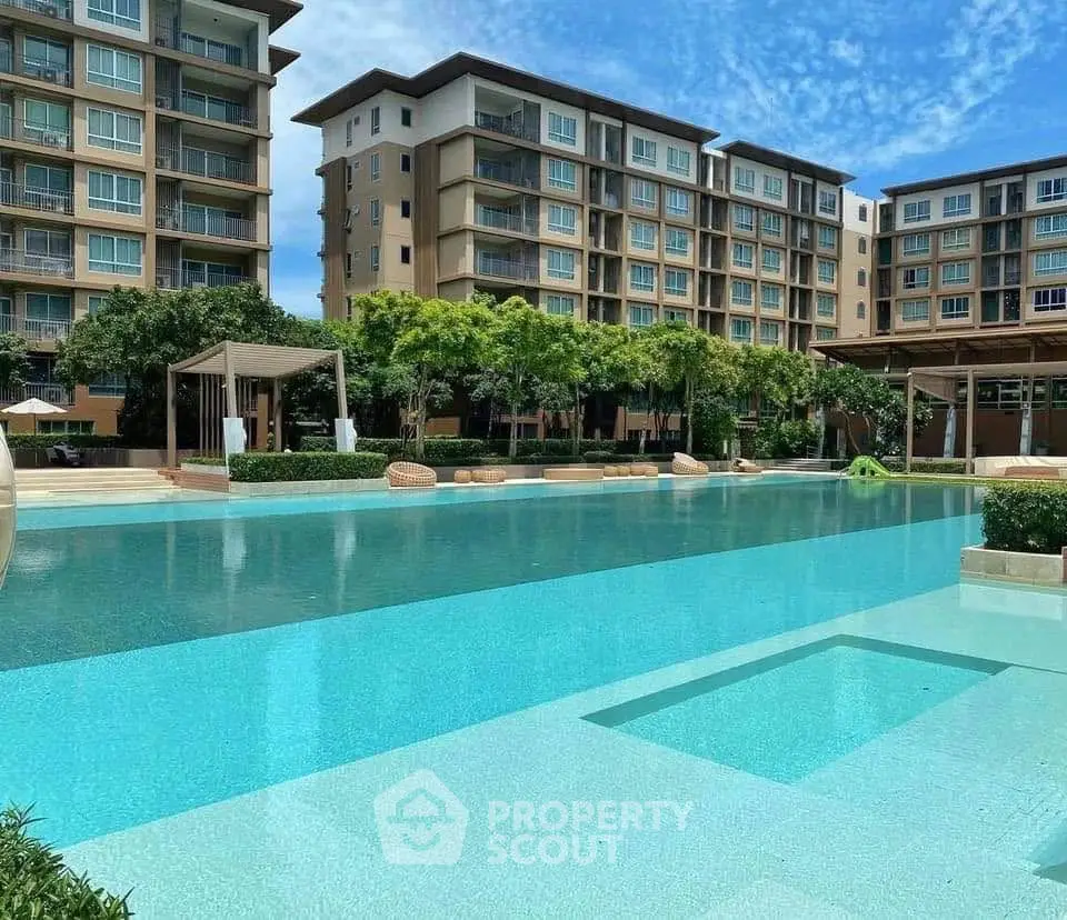 Luxurious residential complex with a stunning pool and modern architecture.