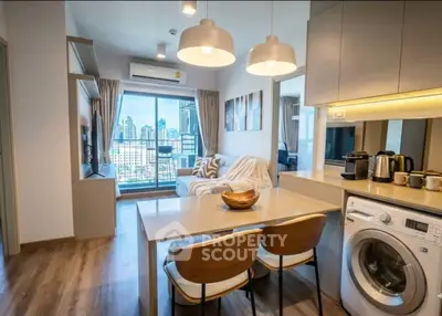 Modern living room with city view, stylish decor, and integrated kitchen appliances.