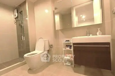 Modern bathroom with sleek fixtures and spacious shower in a contemporary home.