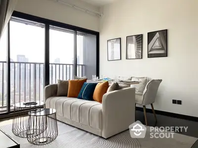 Chic modern living room with plush sofa, stylish armchair, and expansive windows offering an urban view, perfect for upscale city living.