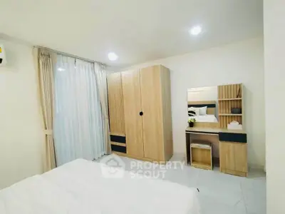 Modern bedroom with sleek wooden furniture and soft lighting