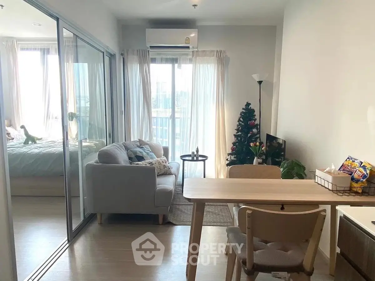 Cozy living room with dining area and bedroom view, perfect for modern living.
