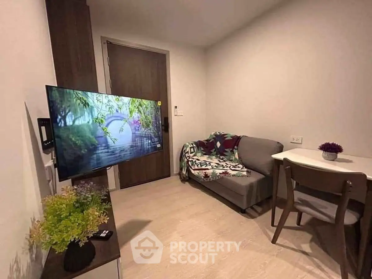 Cozy living room with modern TV setup and comfortable seating area