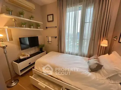 Cozy bedroom with modern decor, featuring a single bed, wall-mounted TV, and natural light from large window.