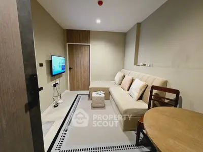 Cozy living room with modern decor and comfortable seating in a stylish apartment.