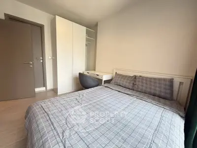 Cozy bedroom with modern furniture and ample natural light, perfect for relaxation and comfort.