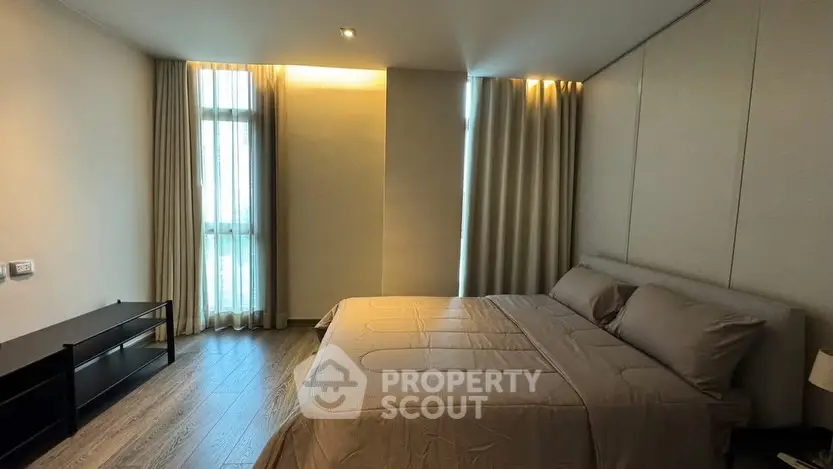 Spacious modern bedroom with large windows and elegant decor