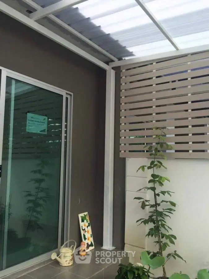 Modern patio with sliding glass door and decorative plants