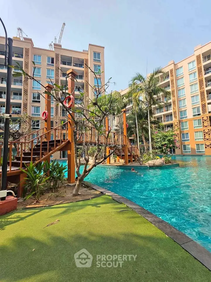 Luxurious apartment complex with stunning pool and lush landscaping, perfect for modern living.
