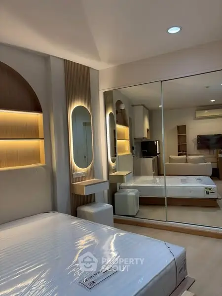 Modern bedroom with stylish lighting and mirrored wardrobe