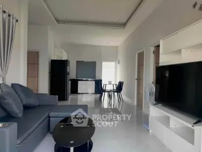 Modern living room with sleek furniture and open kitchen layout