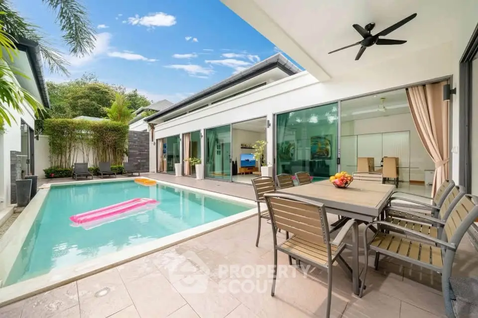 Luxurious villa with private pool and spacious patio, perfect for outdoor dining and relaxation.