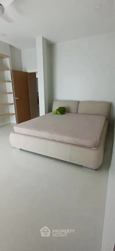 Spacious bedroom with modern design and cozy bed in minimalist style.