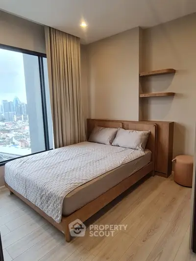 Modern bedroom with city view, featuring wooden bed frame and stylish shelves, perfect for urban living.