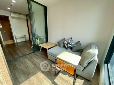 Modern living room with cozy sofa and wooden flooring in bright apartment