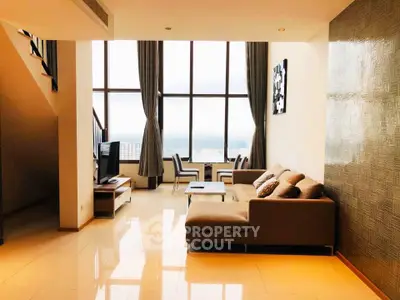 Luxurious high-rise living room with floor-to-ceiling windows and stunning city views.