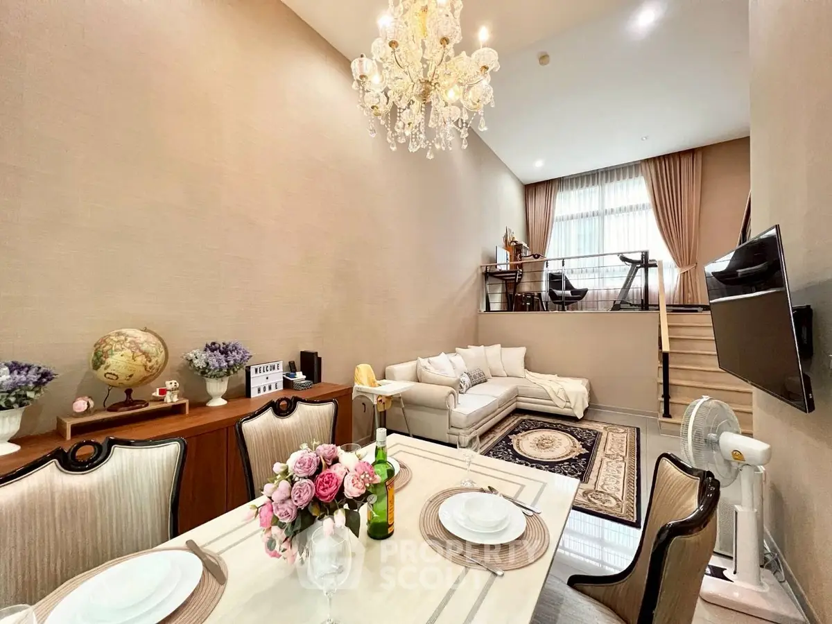 Luxurious split-level living room with elegant chandelier and cozy seating area
