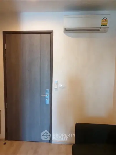 Modern interior with wooden door and air conditioning unit in cozy living space.