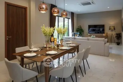 Elegant open-concept living and dining area with modern decor and stylish lighting.
