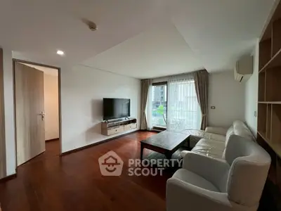 Spacious living room with modern furniture and large windows offering natural light.
