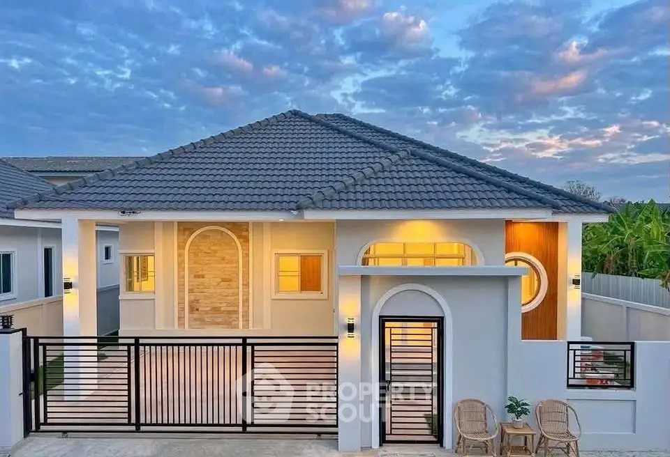 Charming modern house with elegant facade and spacious driveway under a picturesque sky.