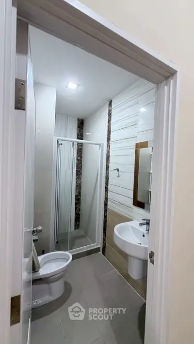 Modern bathroom with sleek shower and elegant fixtures in a contemporary home.