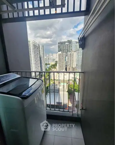 High-rise balcony with washing machine and stunning cityscape view